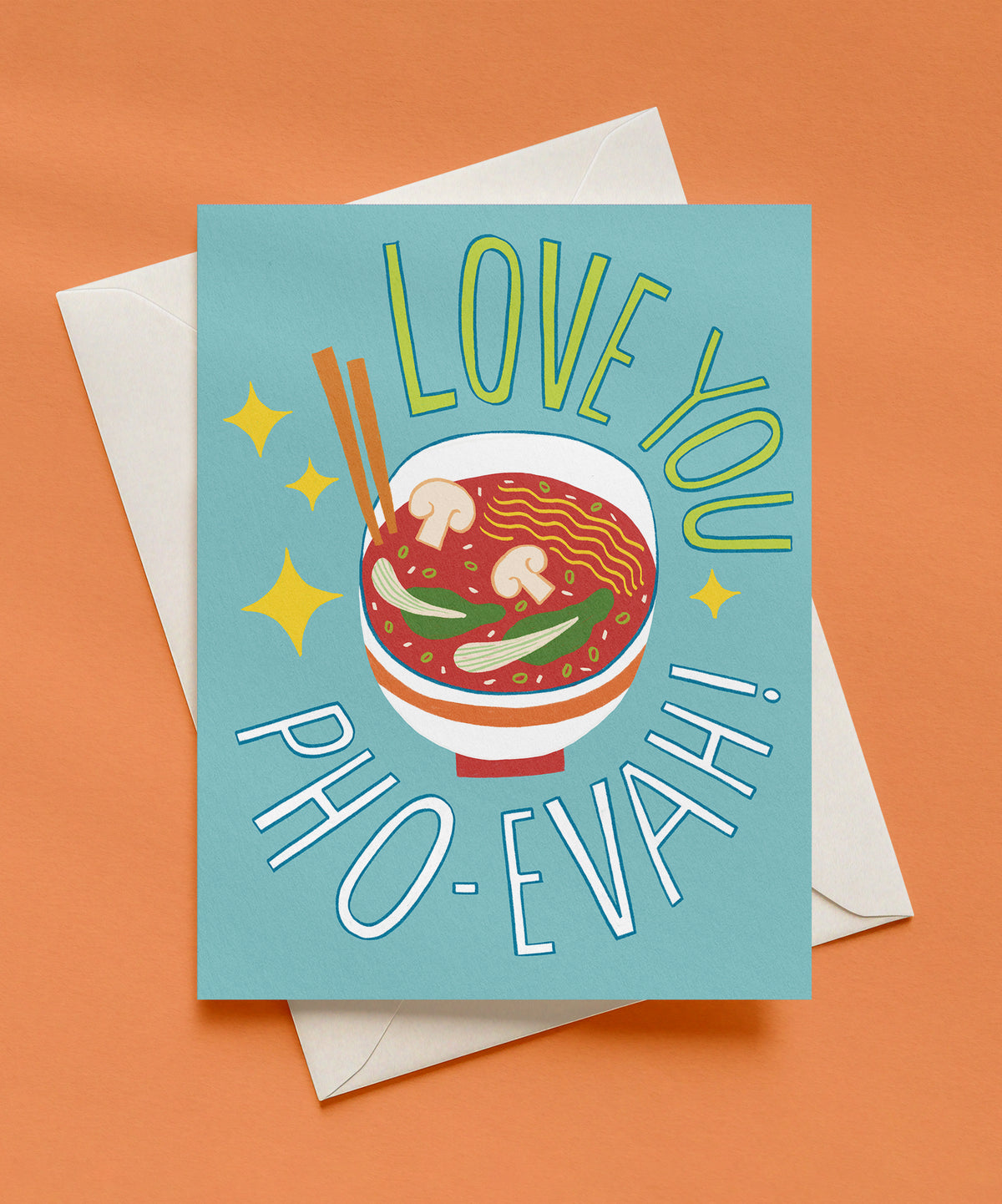 Love You Pho-evah greeting card with a bowl of pho with noodles, mushrooms, and chopsticks on a light teal background, shown with a cream envelope